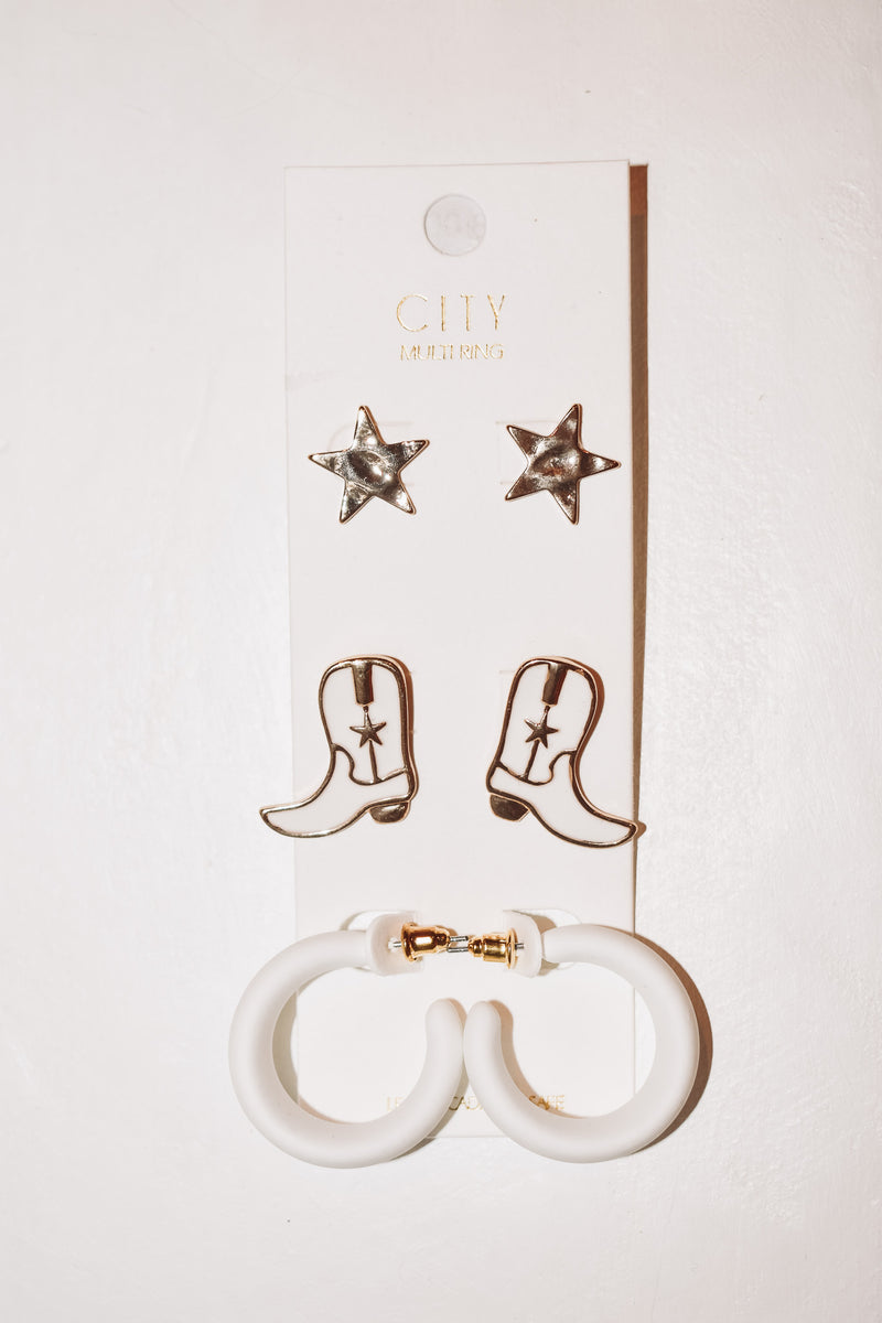 cowgirl’s western boots and hoops earrings 