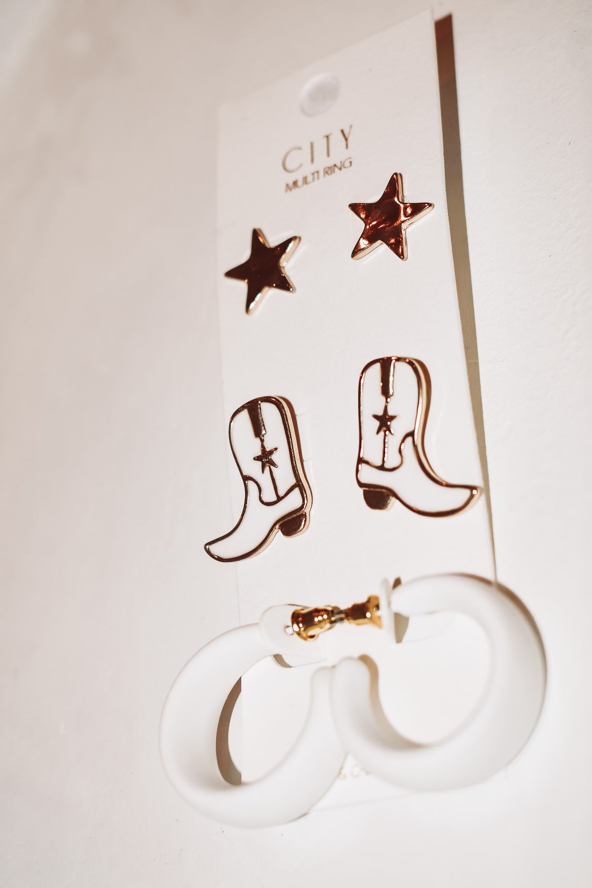 cowgirl’s western boots and hoops earrings 