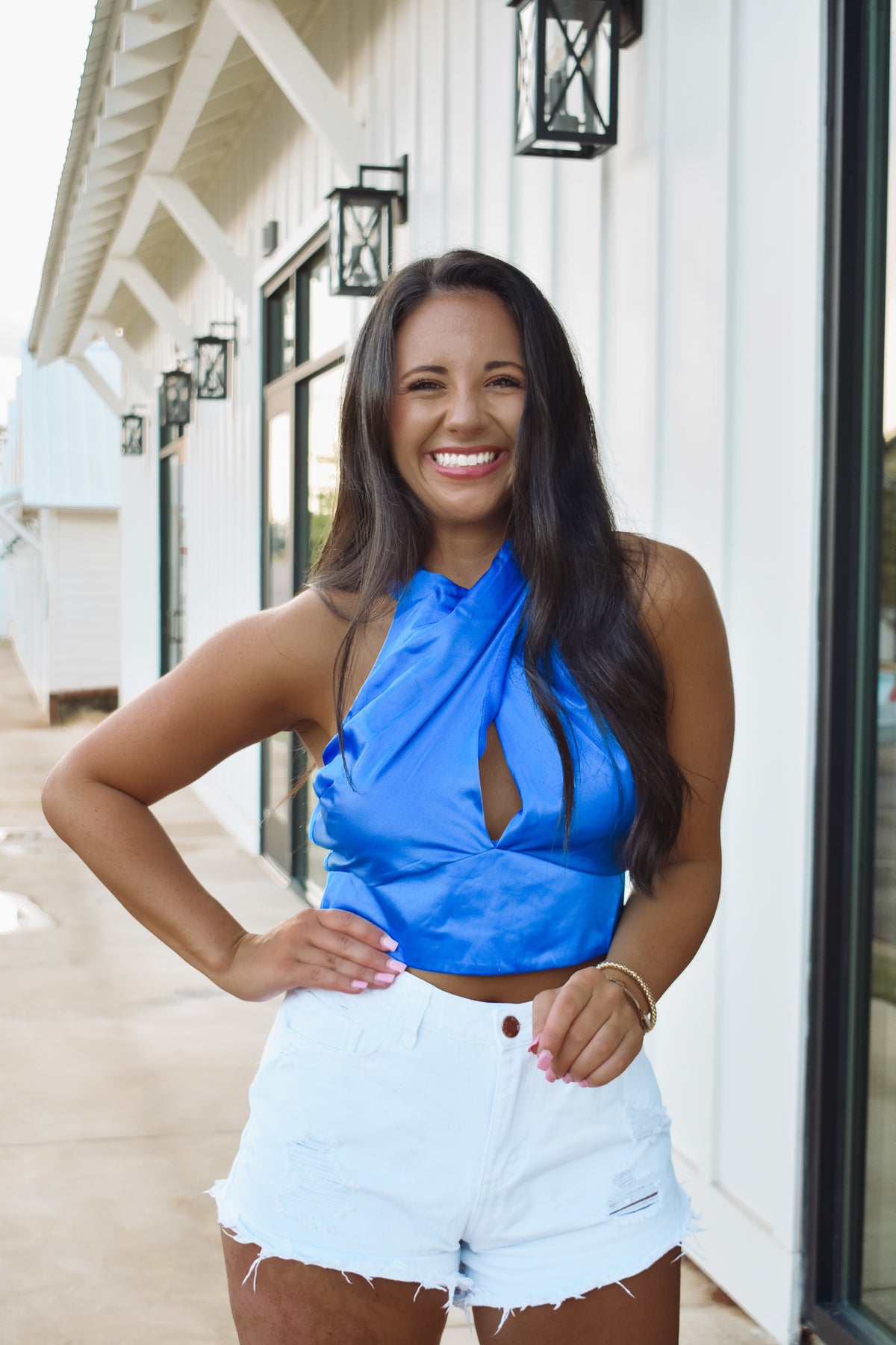 blue cross neck tie top, featuring a cropped fit, satin material,  and a bow tie back.