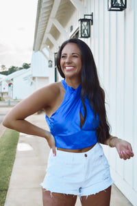 blue cross neck tie top, featuring a cropped fit, satin material,  and a bow tie back.